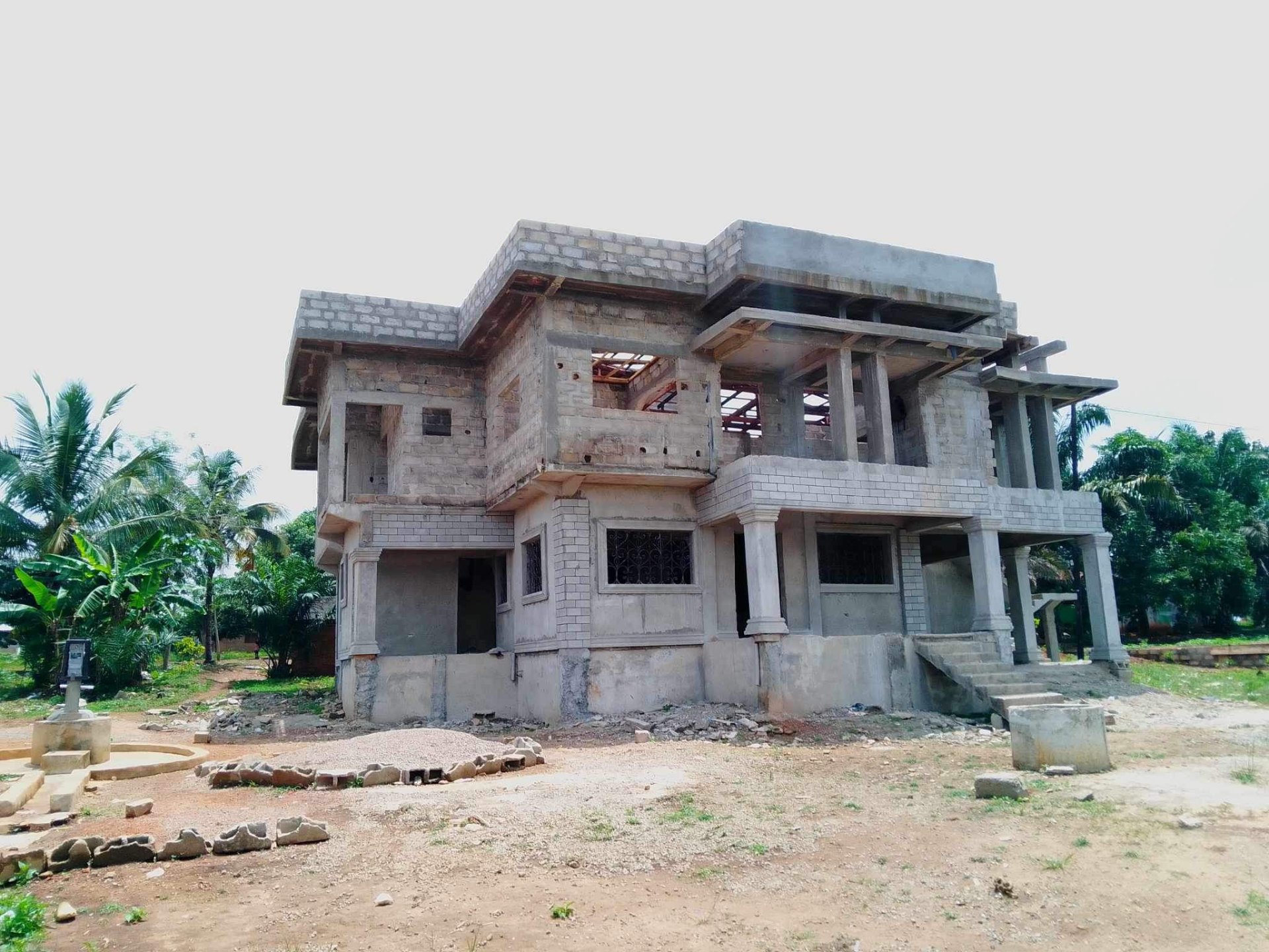 Custom two-story villa with stepped roofline at structural stage