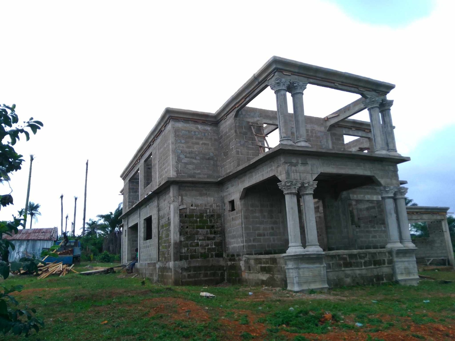 Two-story villa with classical columns under construction